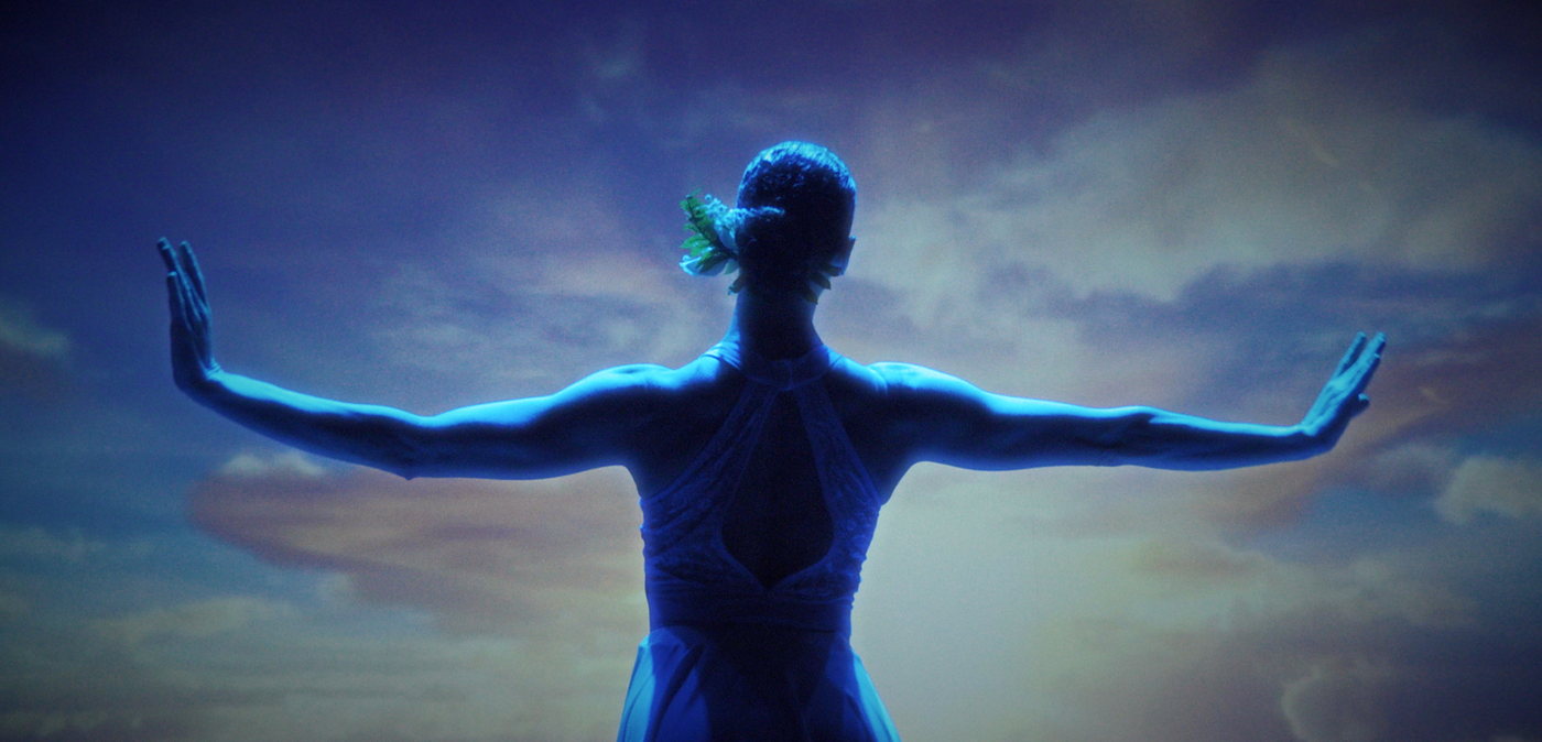 A ballet dancer with arms outstretched.