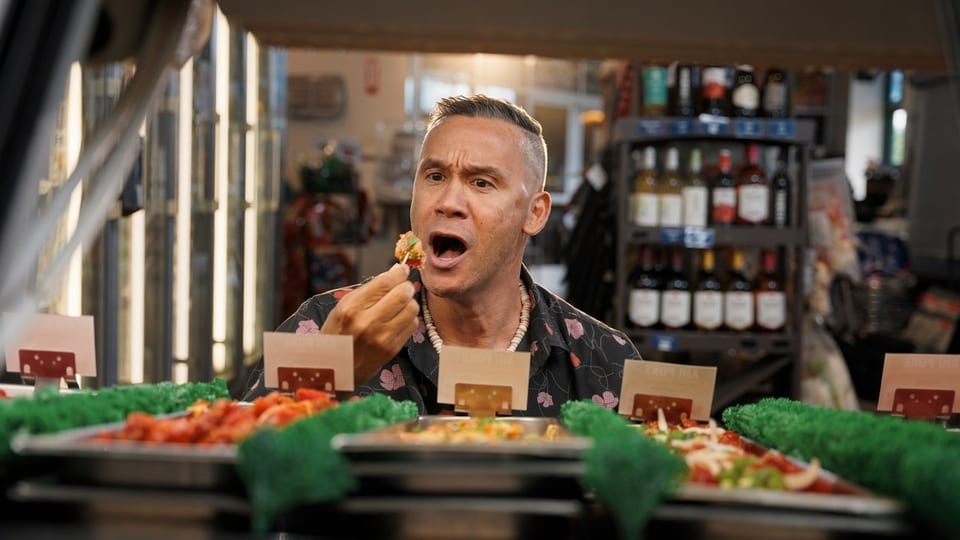 A man sitting at a diner counter enjoying a meal.